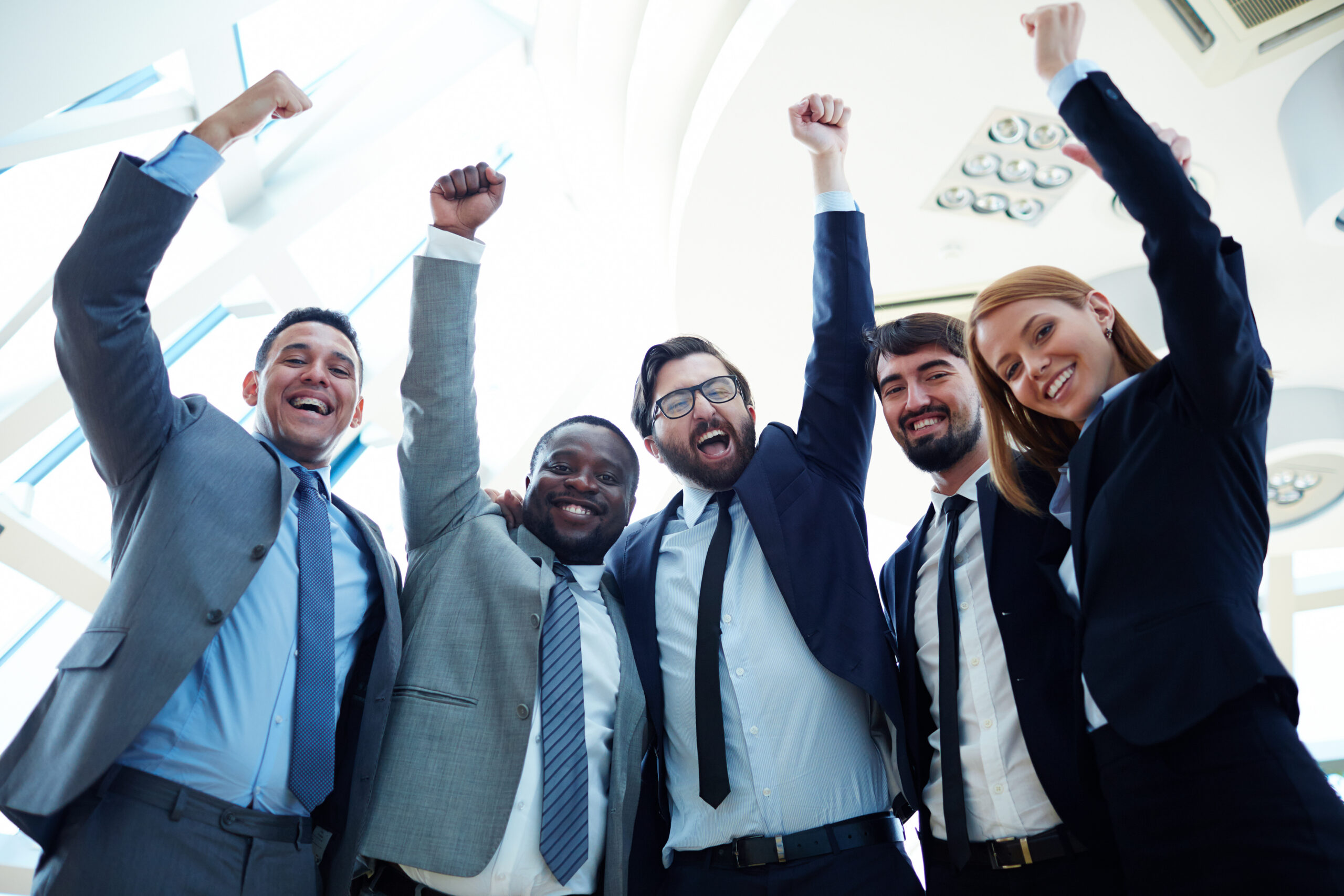 A team of lead generation strategists raising their fists